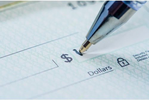Image of pen writing in the Dollar Amount field of a bank check