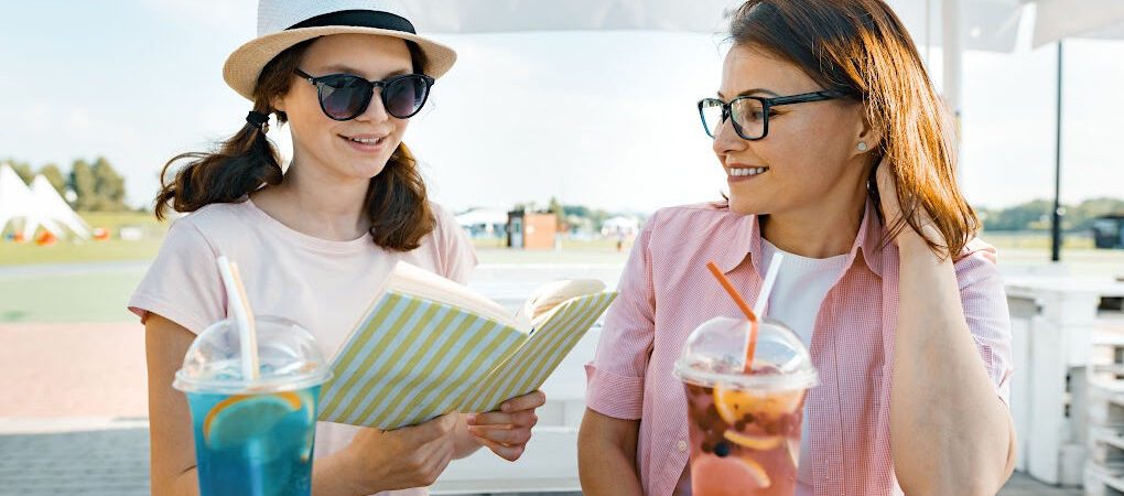 Mom and college-aged daughter reviewing their To Do list to prepare for college move-in day.