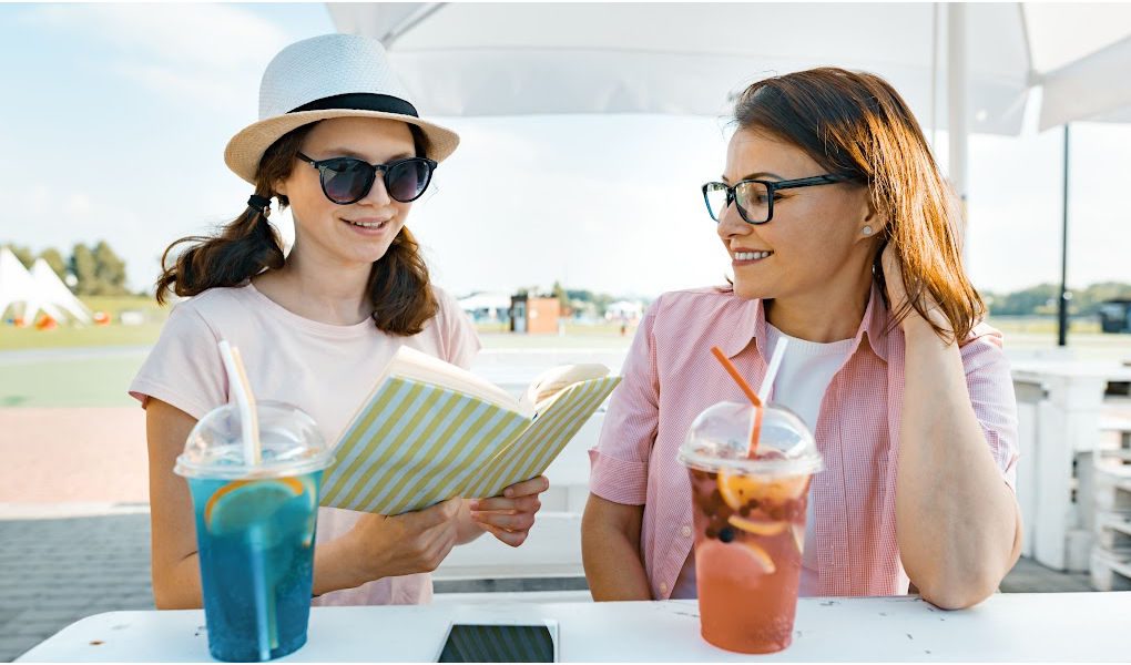 Mom and college-aged daughter reviewing their To Do list to prepare for college move-in day.