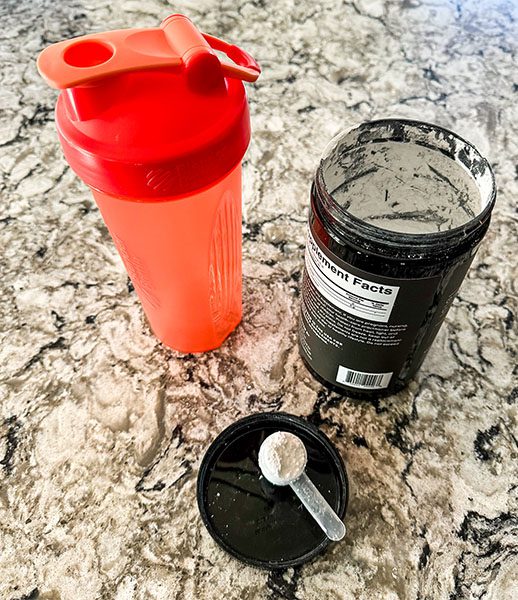 Picture of protein shake bottle and container of creatine supplement