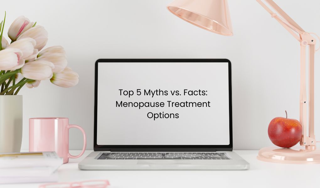 Feminine office desktop with laptop open, on screen of laptop the title reads "Top 5 myths vs. facts: menopause treatment options